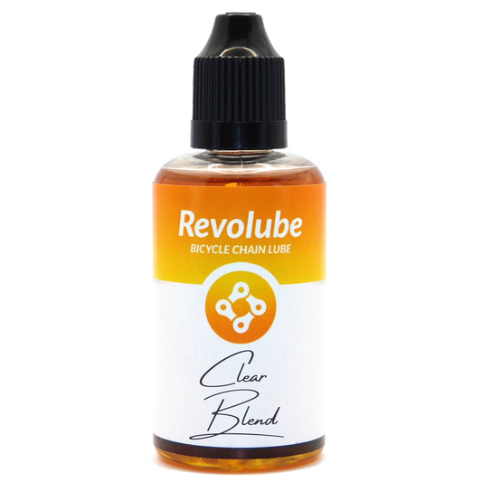 A 50ml bottle of Revolubes Clear Blend bicycle chain lube with a precision applicator.